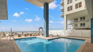 A swimming pool with a view of the beach, a sign with the number 37, and a white fence. - Grandview Oasis! 3BR 2BA Sleeps 9! Gulf-front Tranquility Beckons! (Panama City Beach)