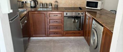 Villa | Private kitchen | Fridge, microwave, oven, stovetop