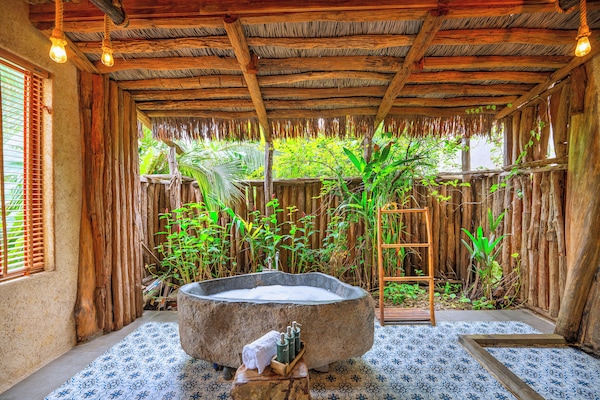 Deep-soaking bathtub, rainfall showerhead, designer toiletries
