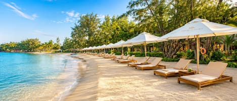 On the beach, sun-loungers, beach umbrellas, beach towels
