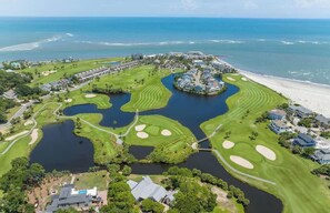 An aerial view of a coastal golf resort with multiple water bodies, a beach, and residential areas. - 362 Speckled Trout (Fripp Island)