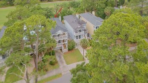 A residential area with multiple houses, surrounded by trees and greenery. - 728 Bonito Road (Fripp Island)