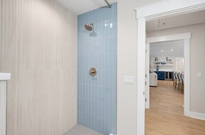 Un baño moderno con ducha, inodoro y lavamanos.
