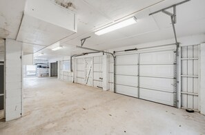 A clean, empty garage with white doors and a concrete floor.