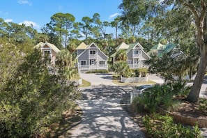 A row of two-story houses with balconies, surrounded by trees and a paved driveway. - 35 Davis Love Drive (Saint Helena Island)