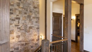 A wooden staircase with a stone wall, wooden beams, and a wooden railing. - 23 Powder Ridge - Managed by Purgatory Resort (Durango)