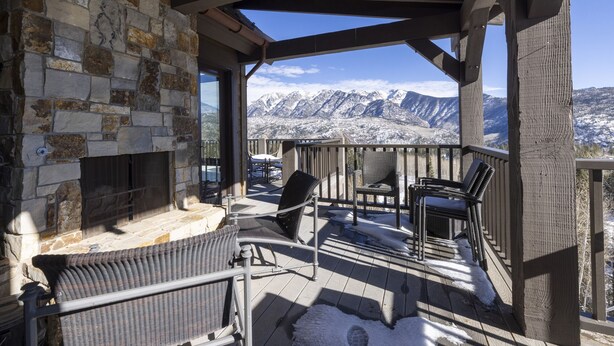 A stone fireplace, outdoor seating, and a mountain view. - 23 Powder Ridge - Managed by Purgatory Resort (Durango)