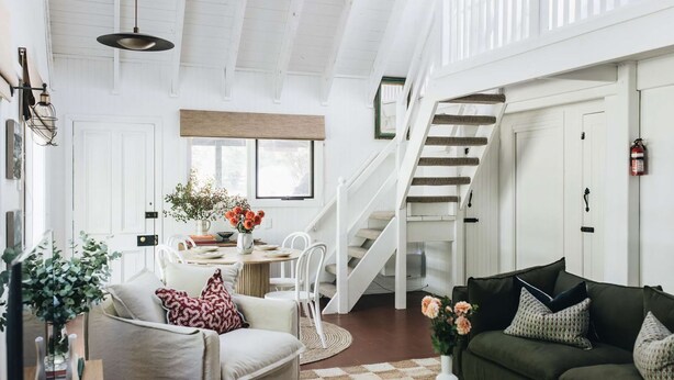A spacious living area with a staircase, a dining table with chairs, and a sofa. - Coromandel Cottage, Berrima (Berrima)