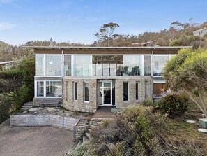 A two-story stone building with a glass facade, a visible entrance, and a sign that reads 'SANDBANKS'. - Sandbanks (Separation Creek)