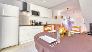A modern kitchen with white cabinets, a built-in microwave, and a stainless steel coffee maker. - Superbe Maison de Vacances à Santa Margarita Immo365 (Roses)