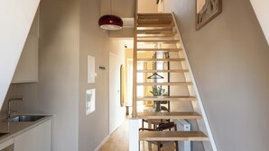 A modern kitchen with a built-in sink and a dining area with a table and chairs.