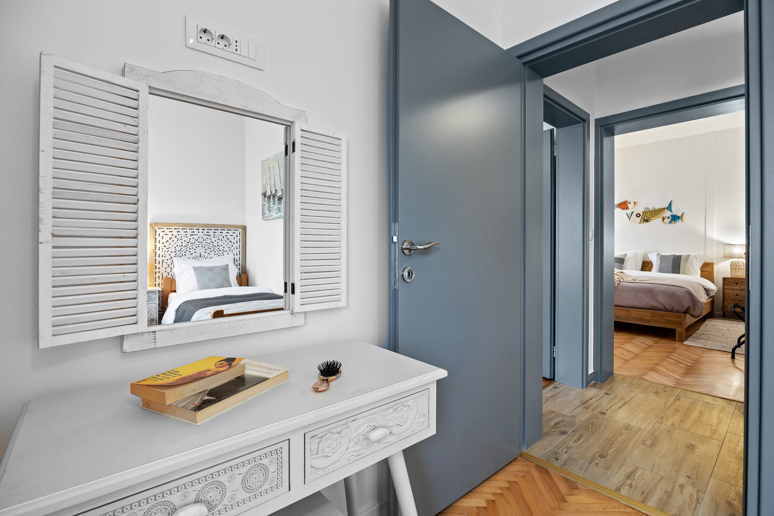 A bedroom with a bed, bedside table, and a dresser.