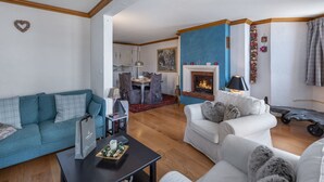 Ein Wohnzimmer mit Kamin, einer Couch, einem Couchtisch und einem Essbereich.