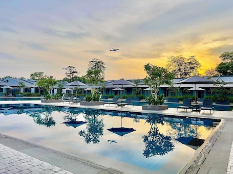 Outdoor pool, open 6:00 AM to 10:00 PM, free cabanas, pool umbrellas