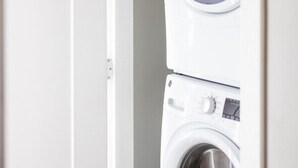 A view of a laundry room with two stacked washing machines. - Luxury Downtown Townhome w/ Private Garage Unit 5 (Cleveland)