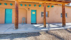A building with a porch supported by wooden beams, two turquoise doors, and a small window. - Quiet Mora Hideaway: 35 Mi to Angel Fire Resort! (Mora)