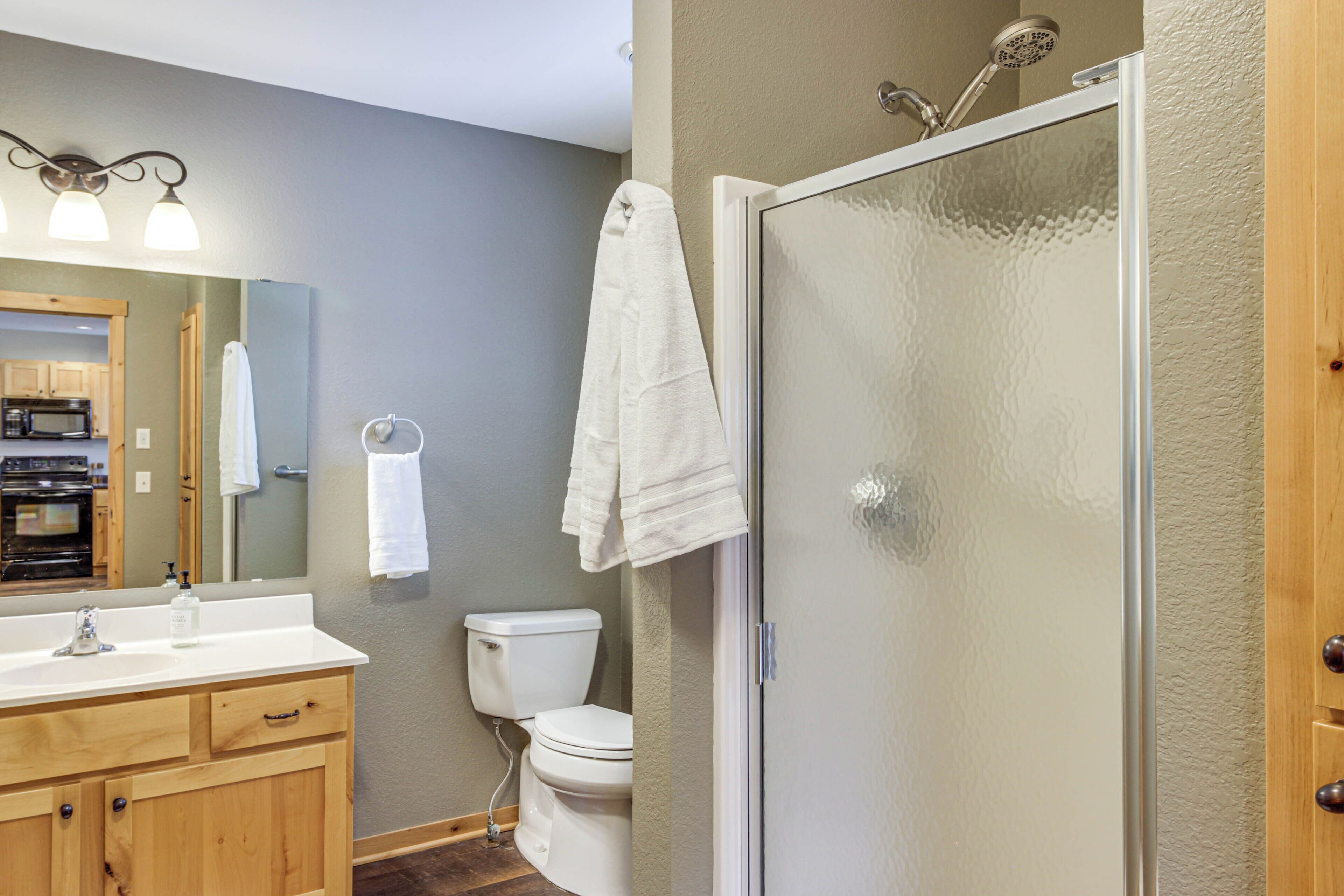 A bathroom with a toilet, sink, and shower.