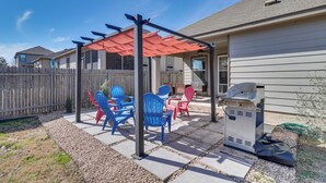 A patio area with a pergola, outdoor seating, and a grill. - Centrally Located Austin Home w/ Private Patio! (Austin)