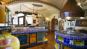 A kitchen with a tiled backsplash, wooden cabinets, and a large central island. - Martinlandia  (Puebla)