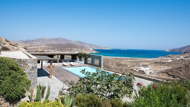 A modern villa with a pool overlooking a coastal landscape. - Mykonian Luxury Villa Victoria with Pool (Mykonos)