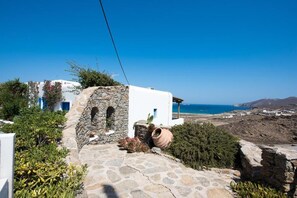 Stroll along the traditional stone pathway to a serene coastal retreat with breathtaking ocean views.
