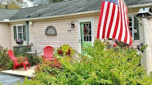 A house with a number 135, a porch with red chairs, and an American flag. - Sunny at 135 is a wonderful place to  (Aiken)