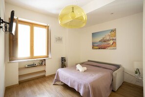 Deluxe Apartment | Living area | 30-inch Smart TV with satellite channels