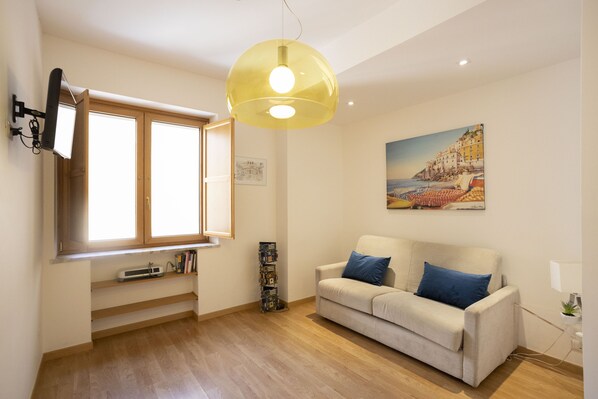 Deluxe Apartment | Living area | 30-inch Smart TV with satellite channels