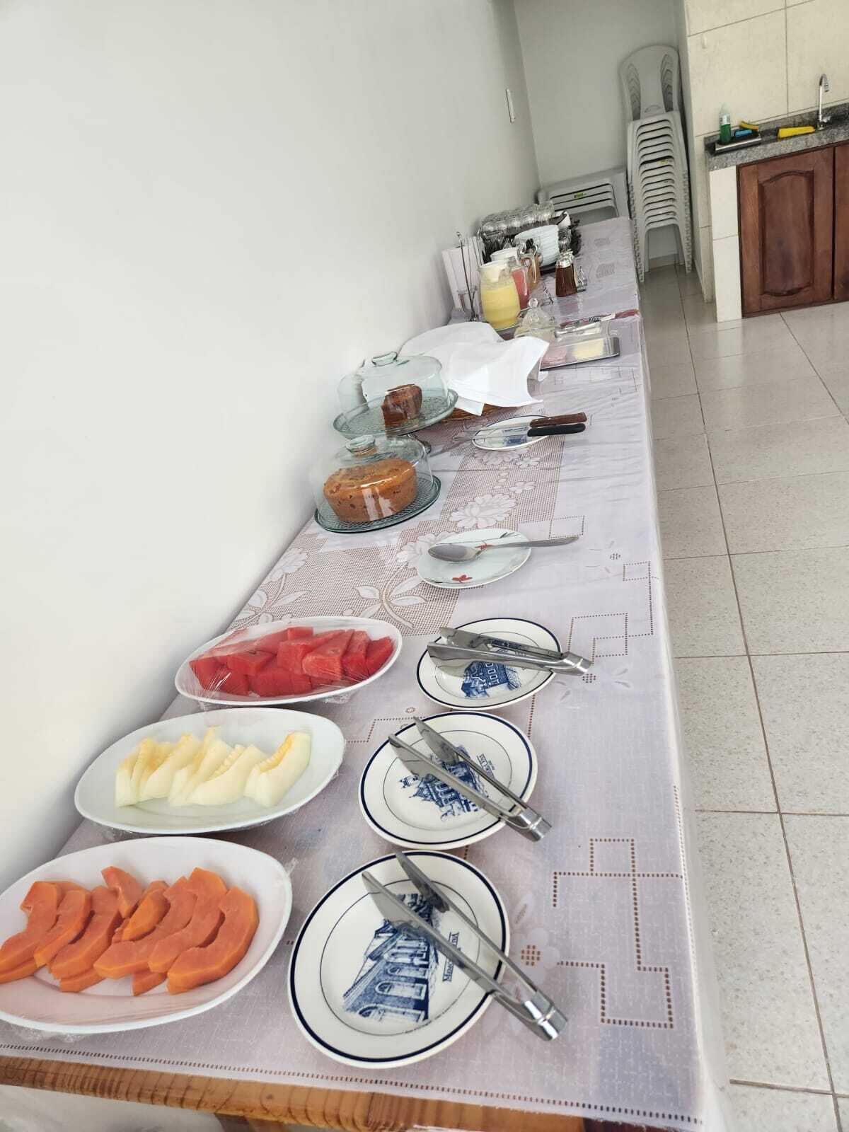 A buffet table with various food items and utensils.