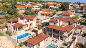 A residential area with modern houses, a swimming pool, and a small playground. - Villa San Zadarvillas (Sveti Filip i Jakov)