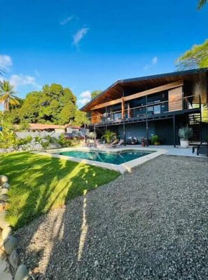 Enjoy a balcony overlooking the pool from this two-story house with a contemporary design.