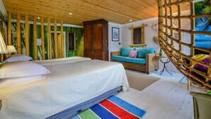 A bedroom with a bed, a sofa, a wooden ceiling, and a view of the outdoors. - The Quay House, Clifden’s oldest building (Clifden)