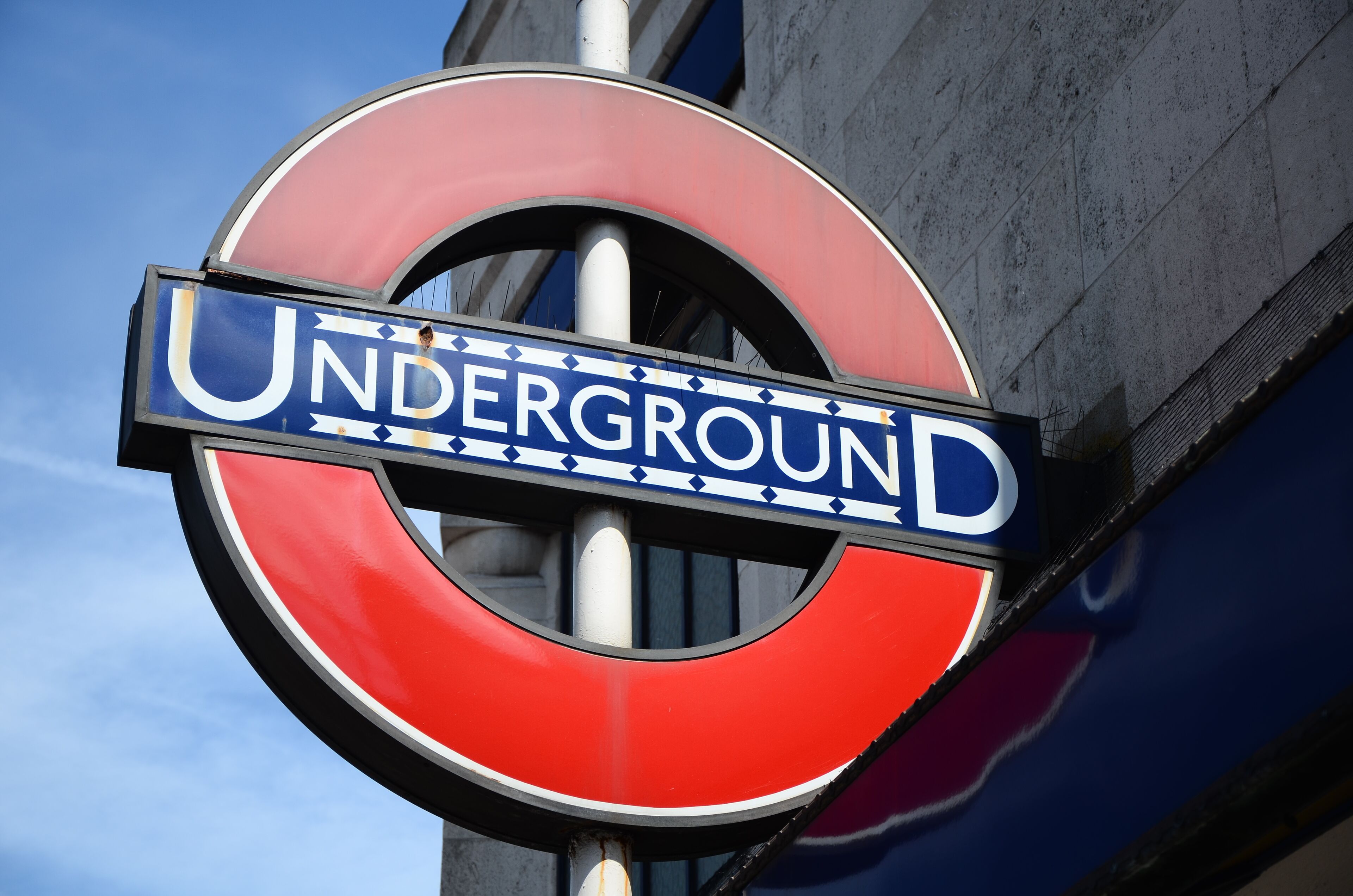 A London Underground sign with a red circle and the word "Underground" in white letters.