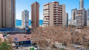 A coastal cityscape with high-rise buildings, a beach, and a parking area. - Edimar 7-6 Apartment Levante Beach (Benidorm)