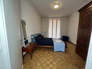 Cozy retreat with a single bed, bedside table, and large mirror.