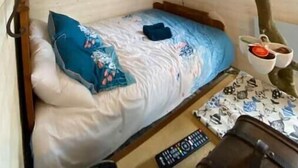 A bedroom with a bed, a night sky ceiling, a small window, and a wall-mounted TV. - The Hobbit du Domaine de la Calotine (Dives-sur-Mer)
