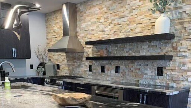 A modern kitchen with a large island, stone backsplash, and built-in appliances. - Fully Remodeled Luxury 1BR | Gondola • A/C • Steam Shower (Telluride)
