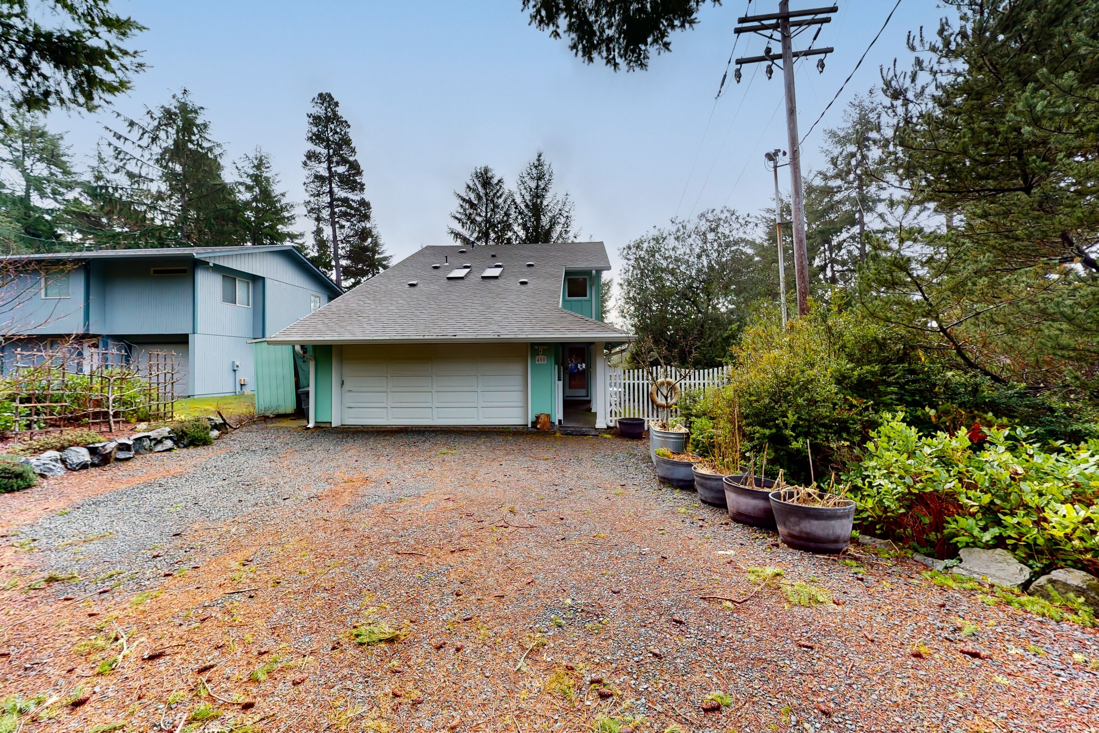 Tree-lined coastal home with wood fireplace, yard, W/D, & games - dog-friendly