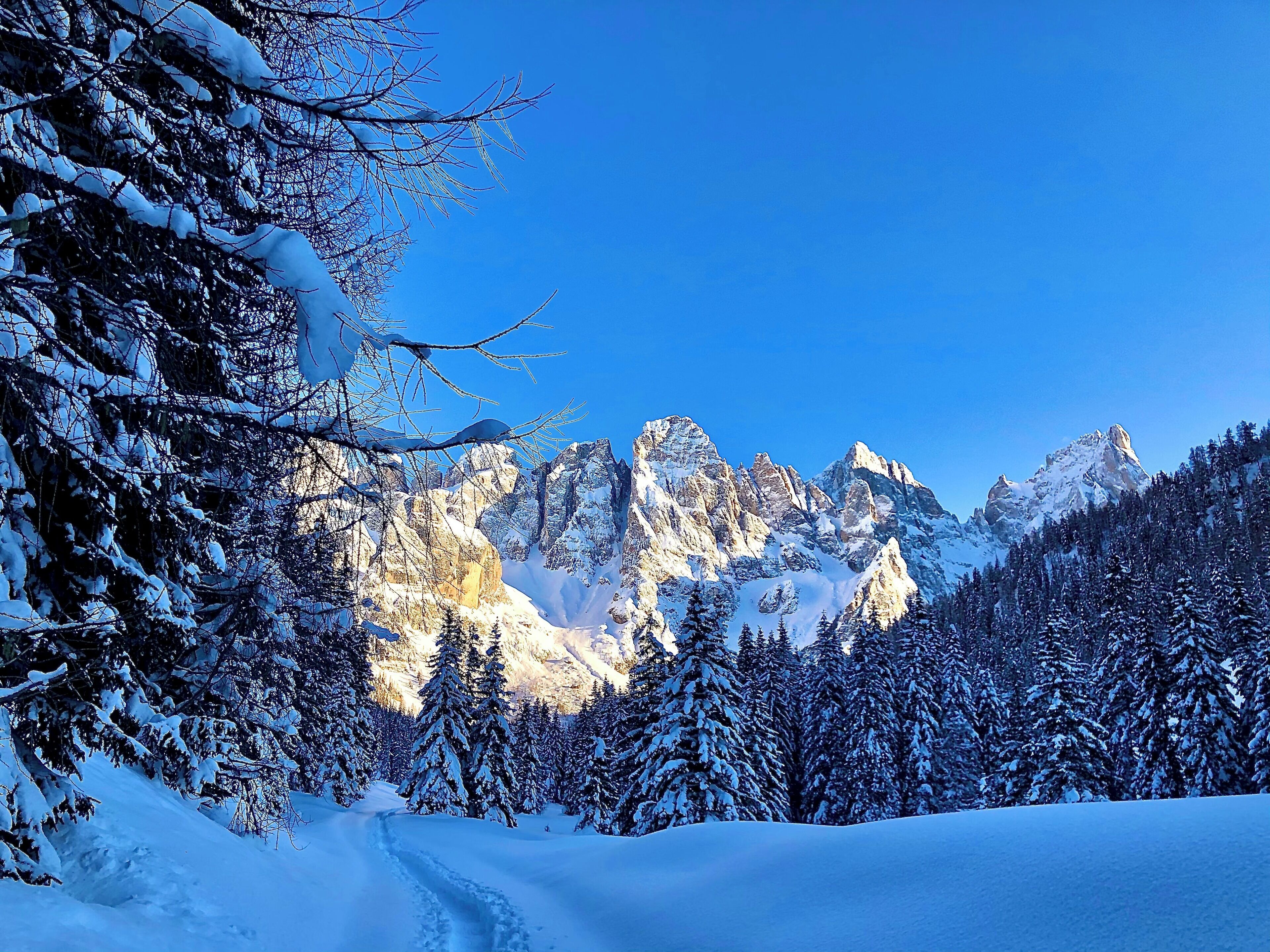 A snow-covered mountain landscape with a clear sky.