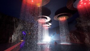 A water feature with multiple circular platforms and a central pool, surrounded by rock-like structures. - Hotel Mirabello - Slow Hotel Benessere (Fiera di Primiero)