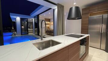 Villa | Private kitchen | Fridge, oven, stovetop, dishwasher