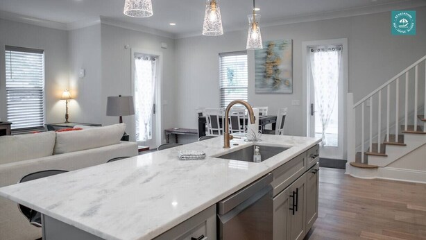 A modern kitchen with a marble countertop, stainless steel appliances, and pendant lighting. - R3 at Inlet Beach with Pool access and EV charger (Inlet Beach)