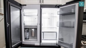 A modern kitchen with a built-in refrigerator, a beverage dispenser, and a stove. - R3 at Inlet Beach with Pool access and EV charger (Inlet Beach)