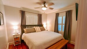 A bedroom with a bed, bedside tables, a ceiling fan, and a window with curtains. - Toccoa River House- Toccoa River Front-2br/2ba-wifi-walk to town-Free Activities (McCaysville)