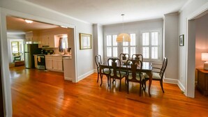 A spacious kitchen with wooden cabinets and a dining area with a table and chairs. - Toccoa River House- Toccoa River Front-2br/2ba-wifi-walk to town-Free Activities (McCaysville)