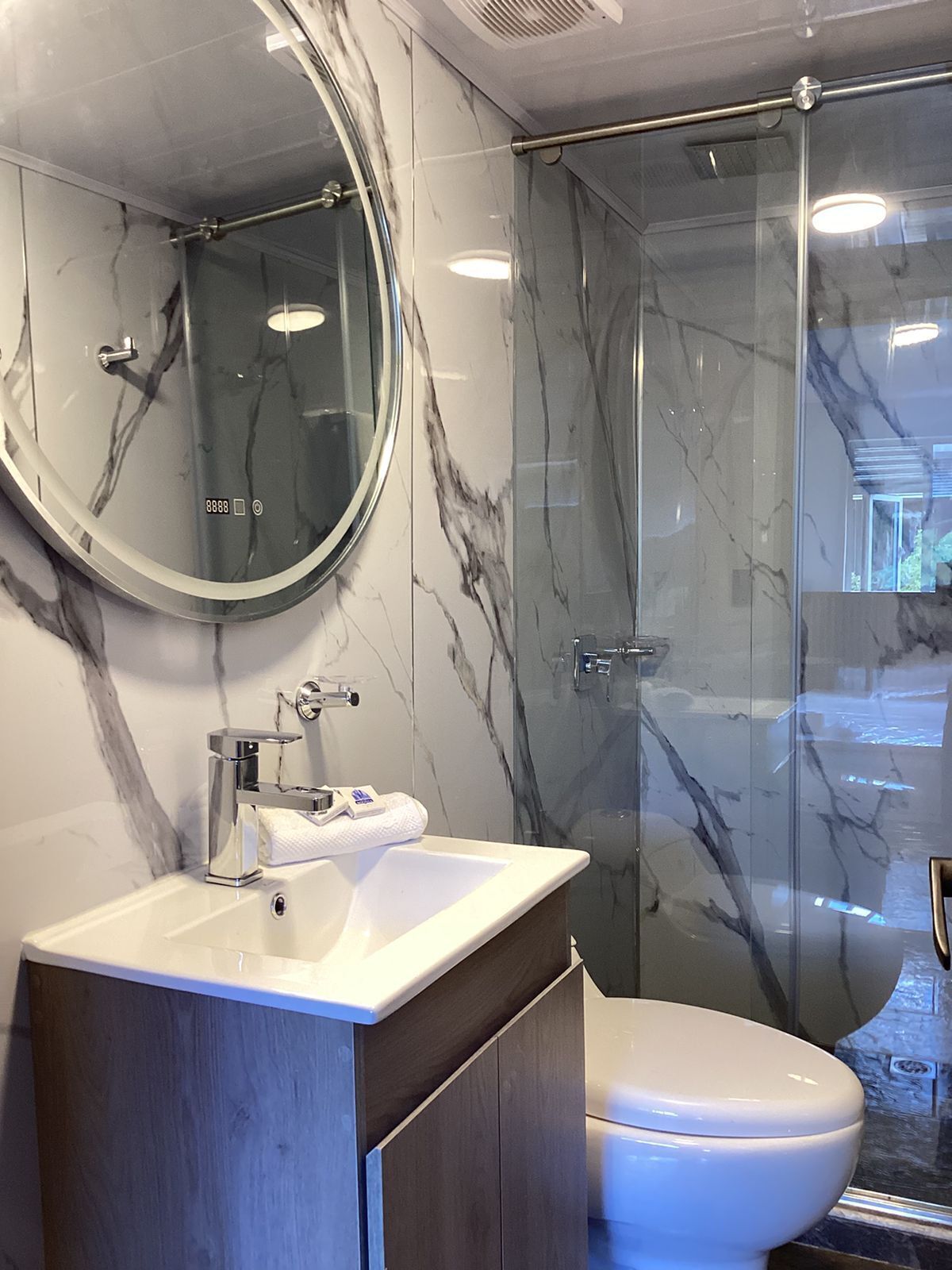 Shower, rainfall showerhead, towels, soap
