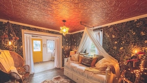 A cozy bedroom with a canopy bed, a wooden floor, and a decorative ceiling. - -Shingle Diggins Cottage- (Coloma)