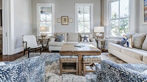 A living room with a sofa, armchairs, a coffee table, and a rug. - Historic Oasis. Heated pool, Historic Oasis. Heated pool spa large backyard (Galveston)