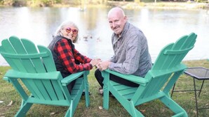 Two people seated on green Adirondack chairs by a lake. - River Estate-Luxury Pool,  Spa (Anderson)