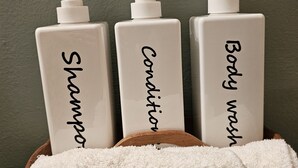 Three bottles of shampoo, conditioner, and body wash in a wooden tray with white towels. - Private Home and Dock on Dunns Creek!
Sportsman's paradise, hosted by Sportsman. (Satsuma)